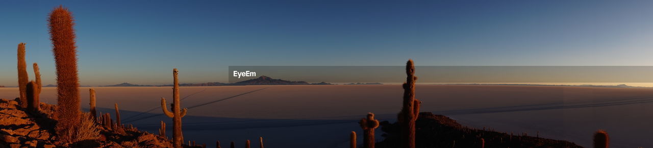 PANORAMIC VIEW OF MOUNTAINS AGAINST CLEAR SKY