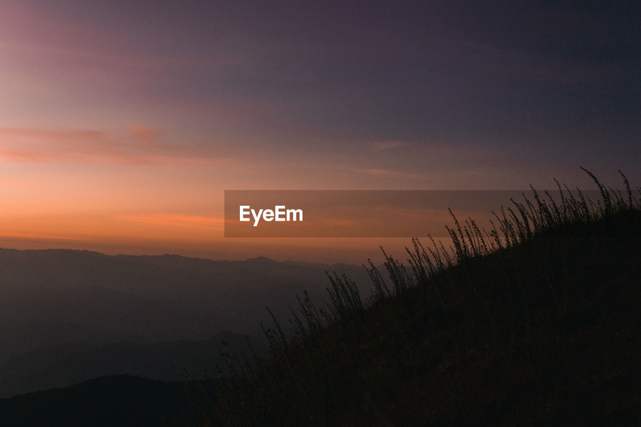 Scenic view of silhouette mountain against sky during sunset