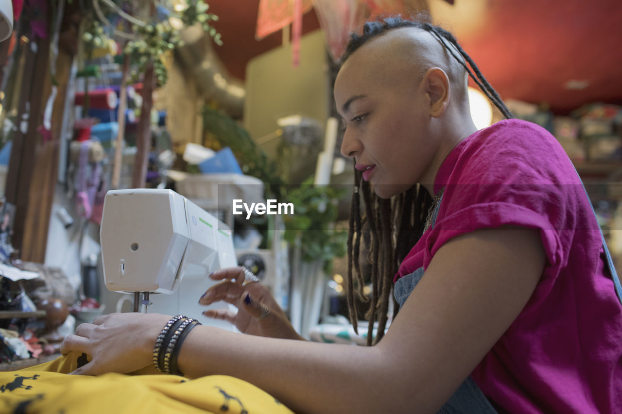 Portrait of stylish young female designer at work