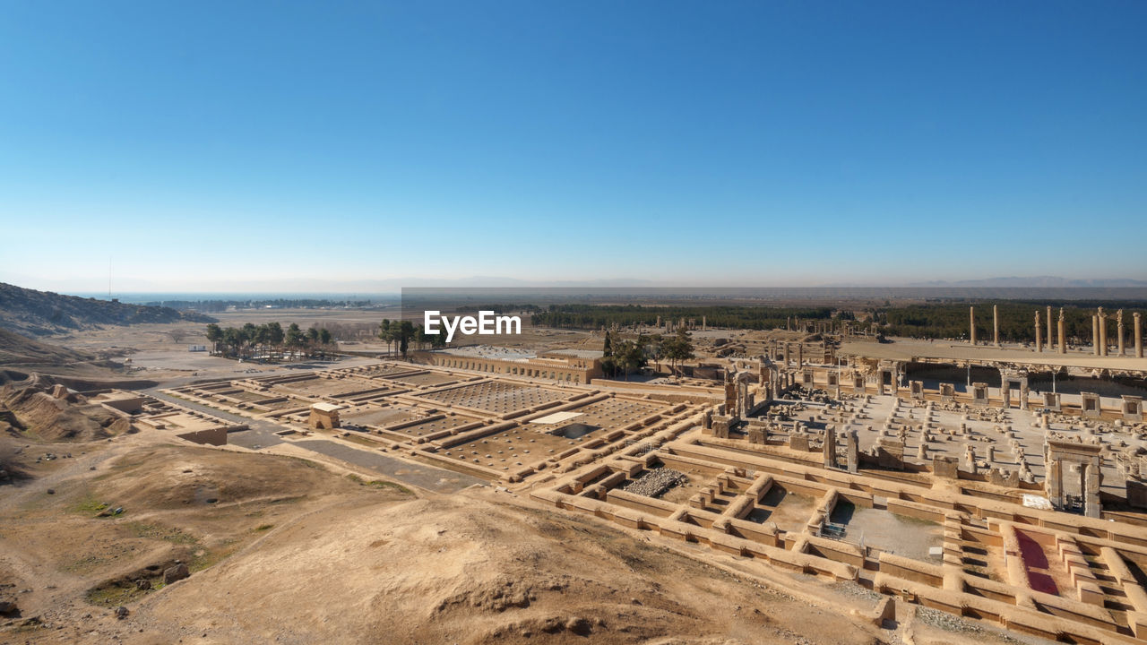 Aerial view of persepolis, ancient capital of persian empire against clear blue sky