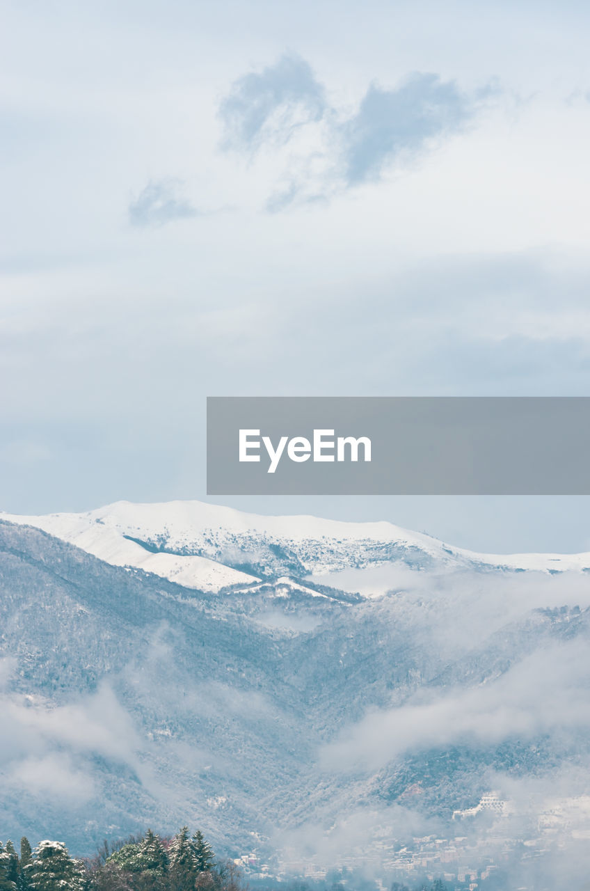 Scenic view of snowcapped mountains against sky