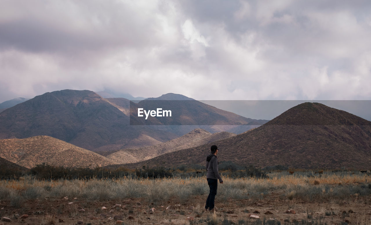 Full length of man standing on land against sky