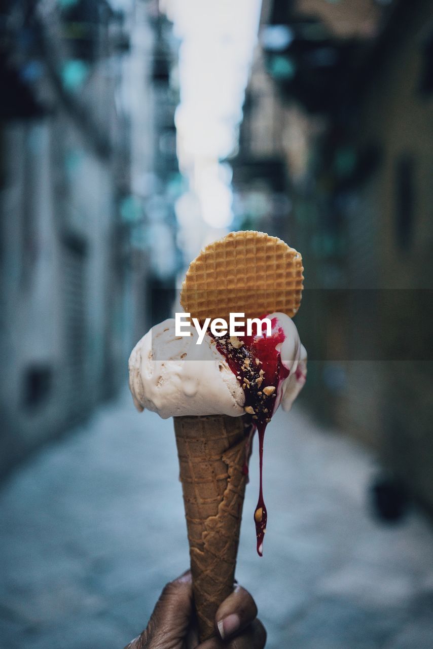 Close-up of hand holding ice cream cone