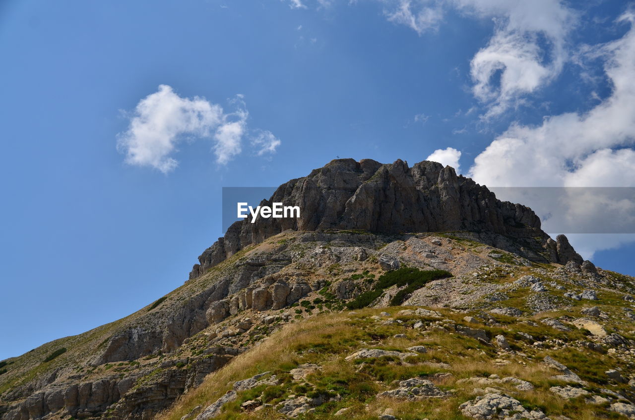 Low angle view of cliff against sky