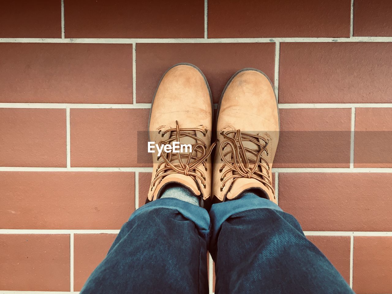 Low section of woman standing on tiled floor