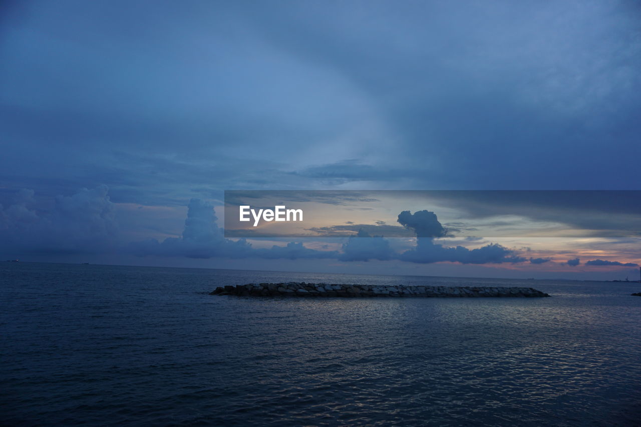 Scenic view of sea against sky at sunset