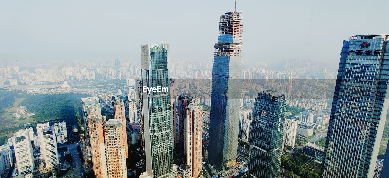 Panoramic view of buildings in city against sky