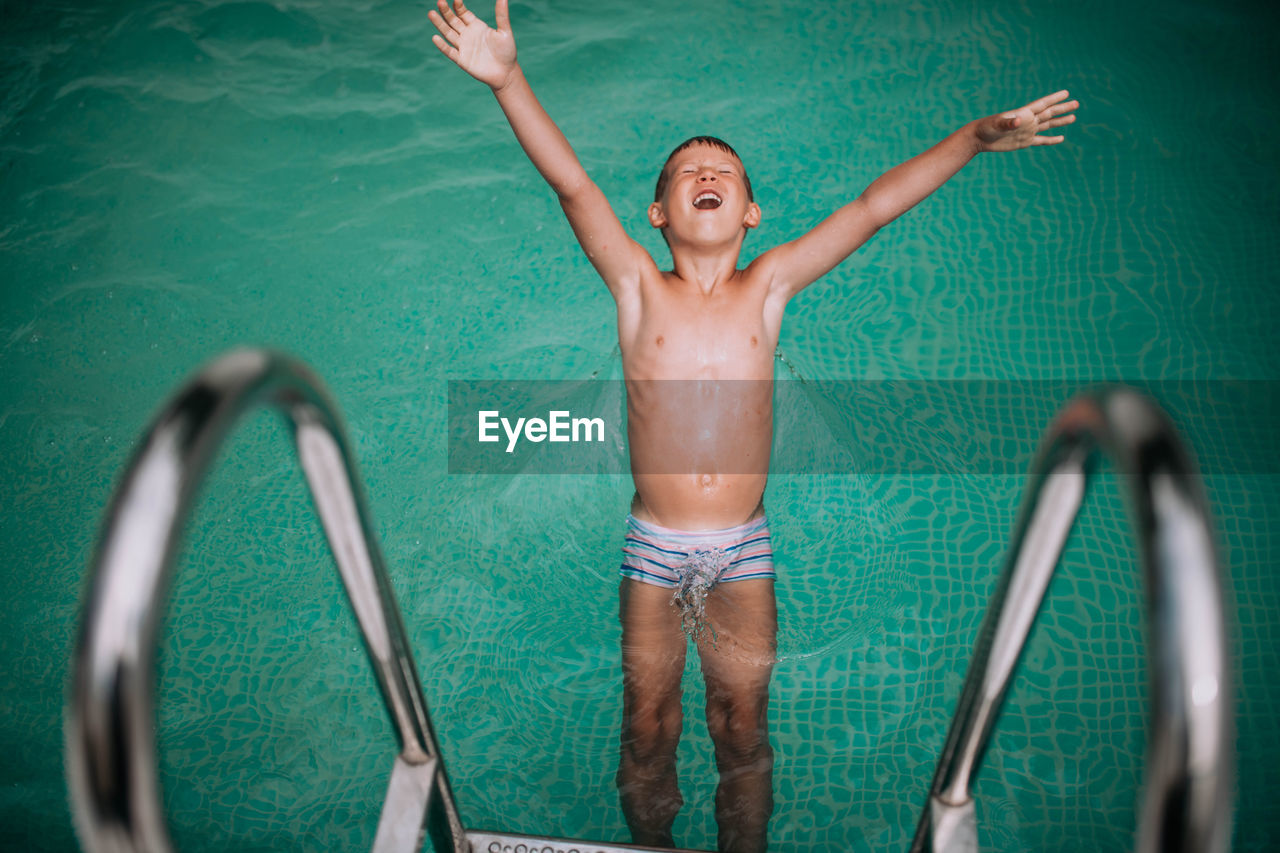 Full length of shirtless boy in swimming pool