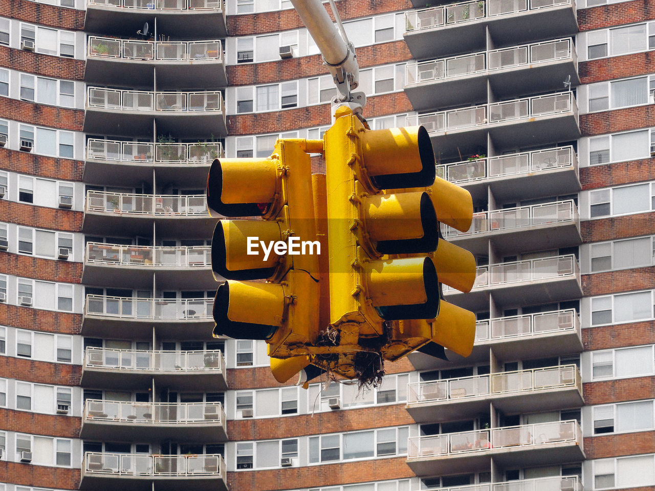 Low angle view of stoplight against buildings