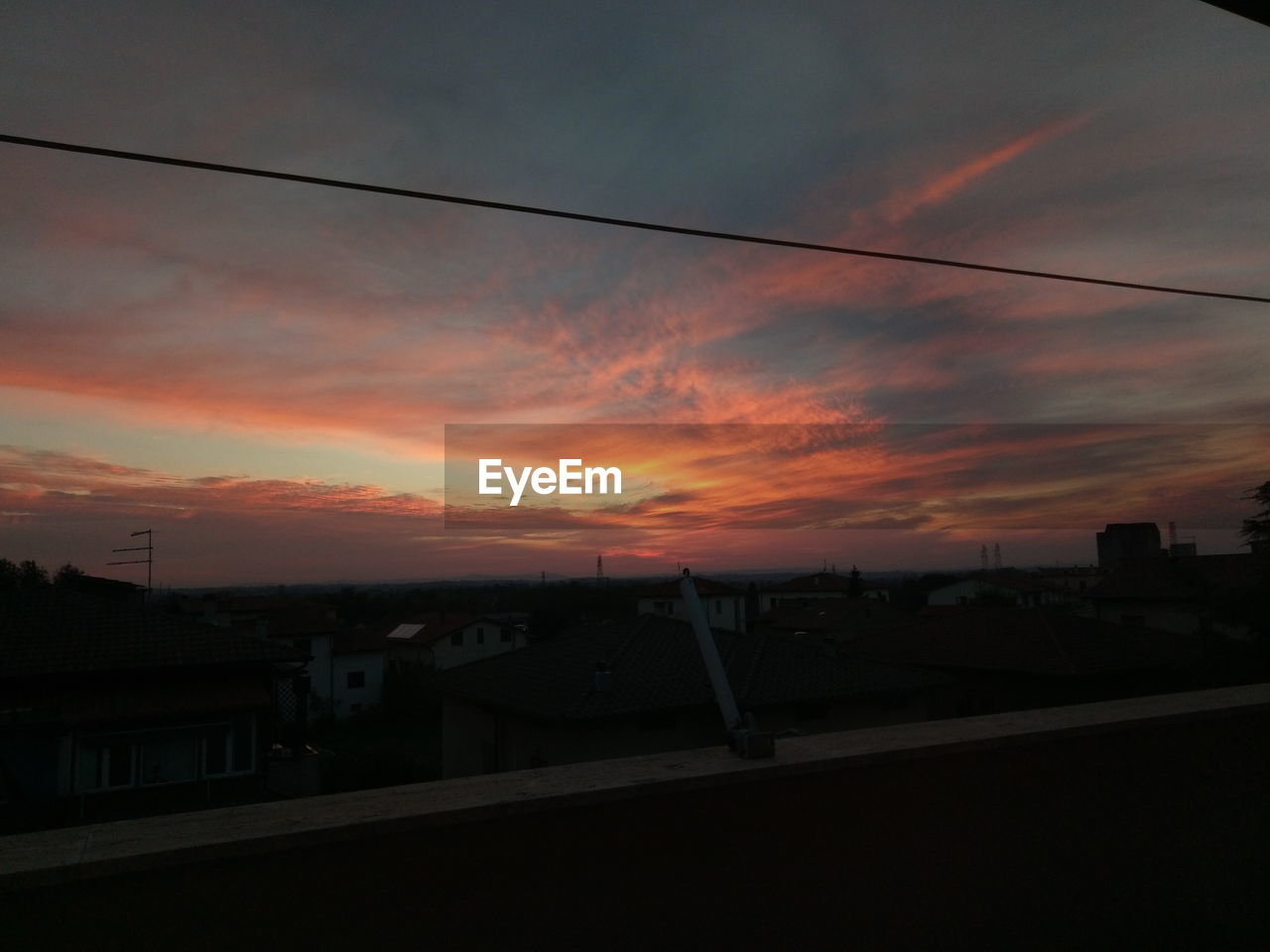 SILHOUETTE BUILDINGS AGAINST ORANGE SKY