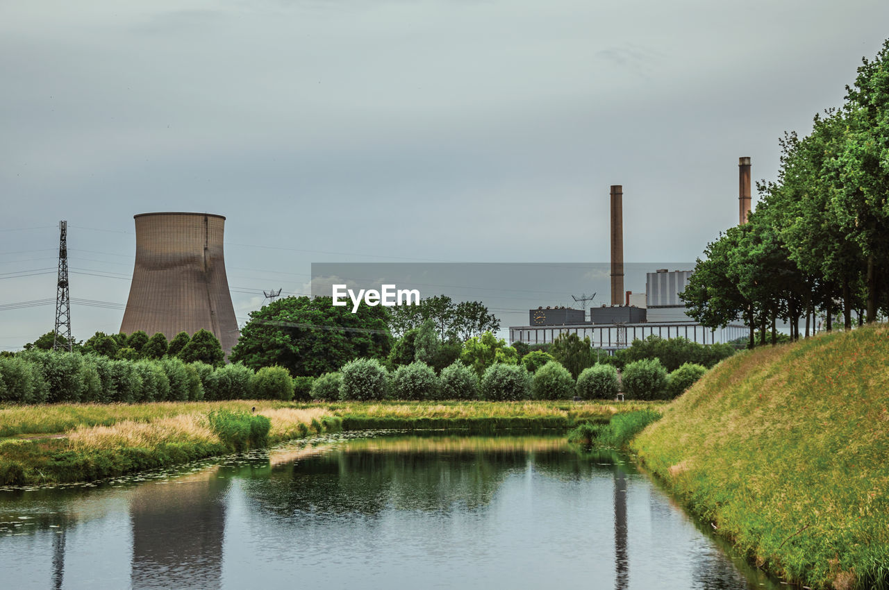Canal and nuclear power plant near geertruidenberg. a small village in the netherlands countryside.