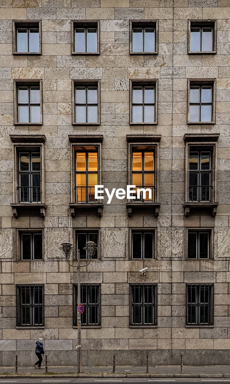 Walking under a surveillance camera by a building in berlin
