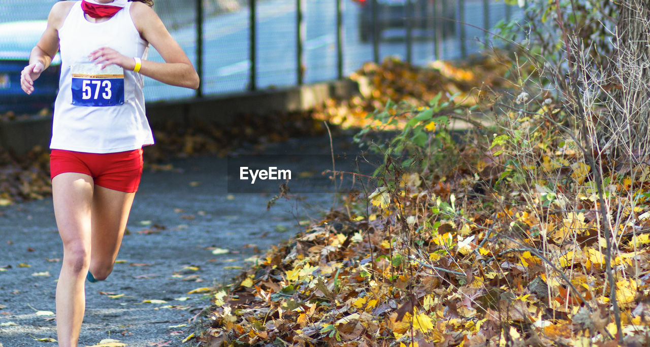 Midsection of woman running outdoors