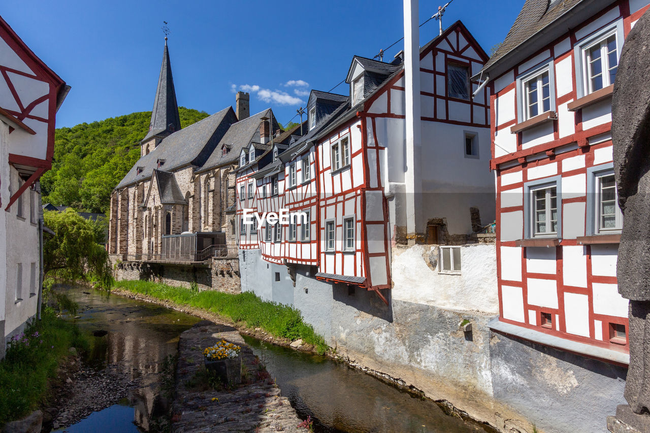 River elz with old bridge and half-timbered houses in monreal, germany