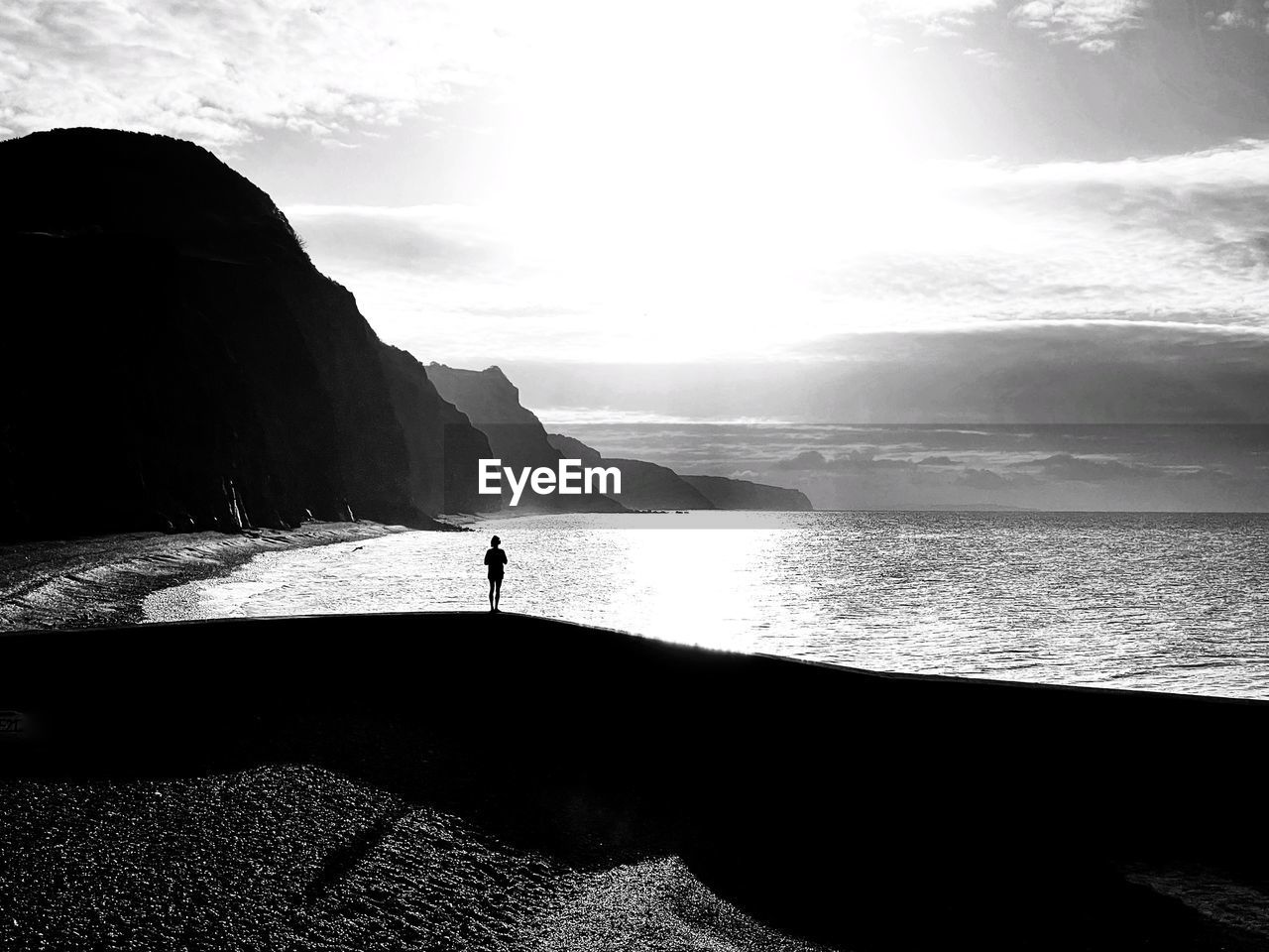 Scenic view of sea and silhouette of person against sky