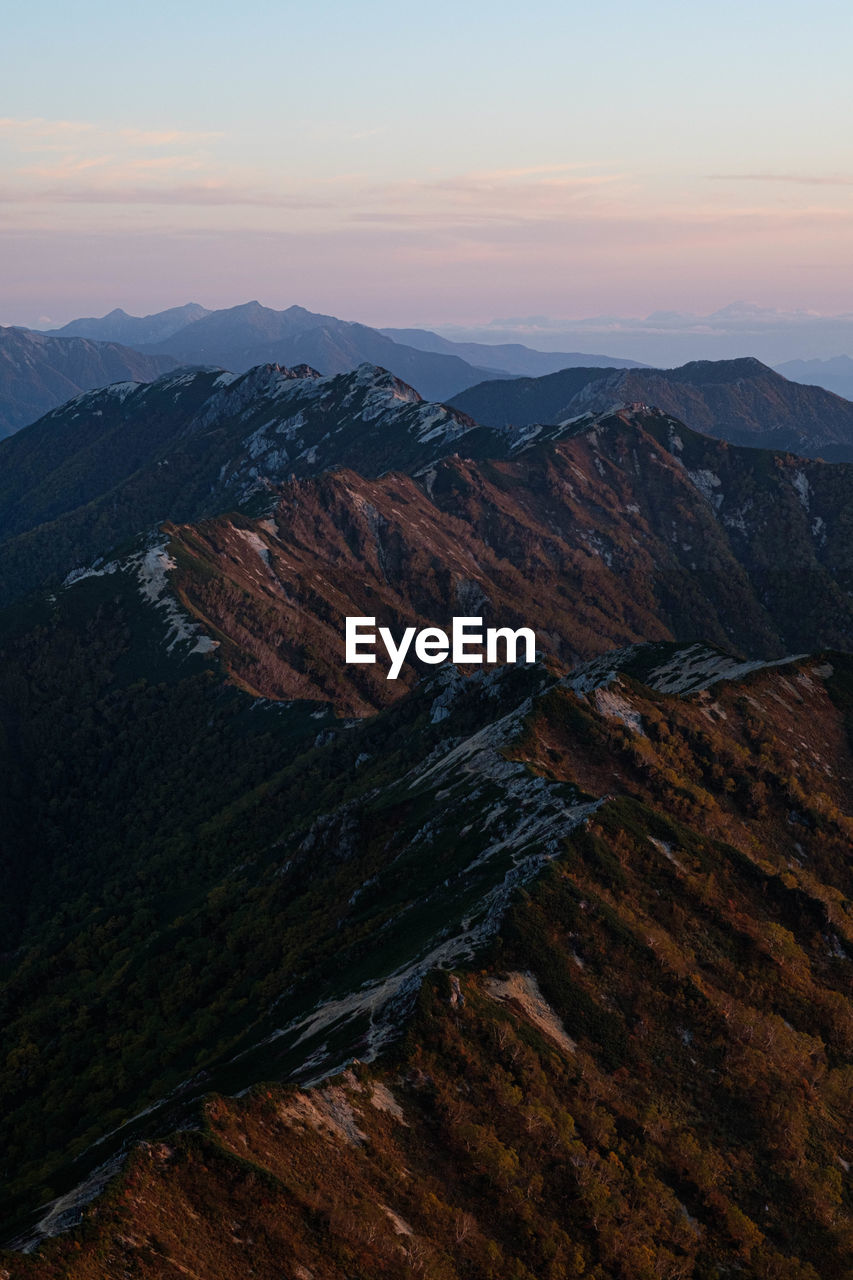 HIGH ANGLE VIEW OF MOUNTAIN AGAINST SKY DURING SUNSET