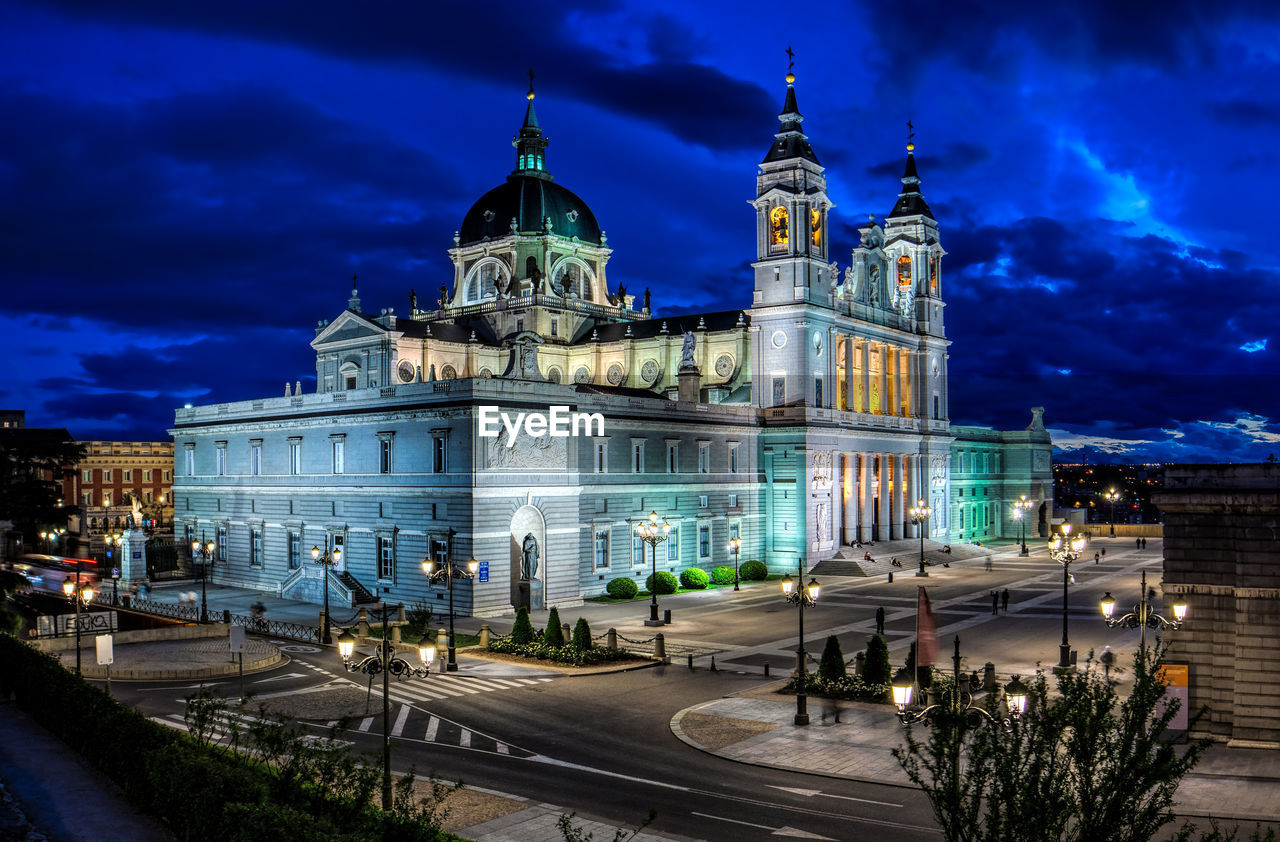 Illuminated almudena cathedral against sky at night