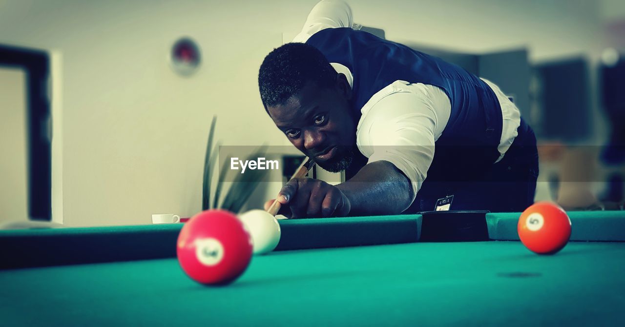 Man playing snooker indoors