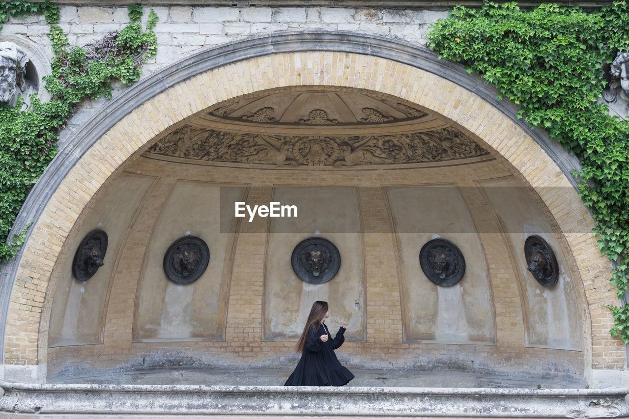 Low angle view of woman walking in historic building