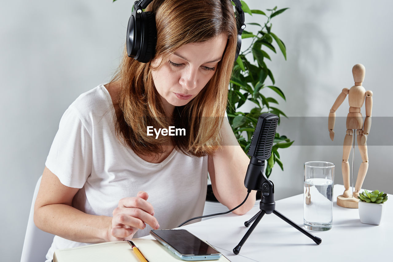 Woman listening online course in headphones, distance education
