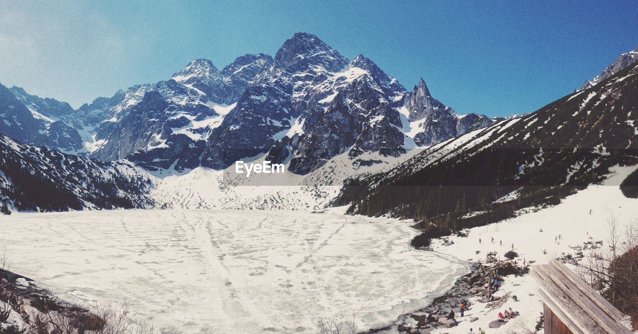 AERIAL VIEW OF SNOWCAPPED MOUNTAIN AGAINST SKY