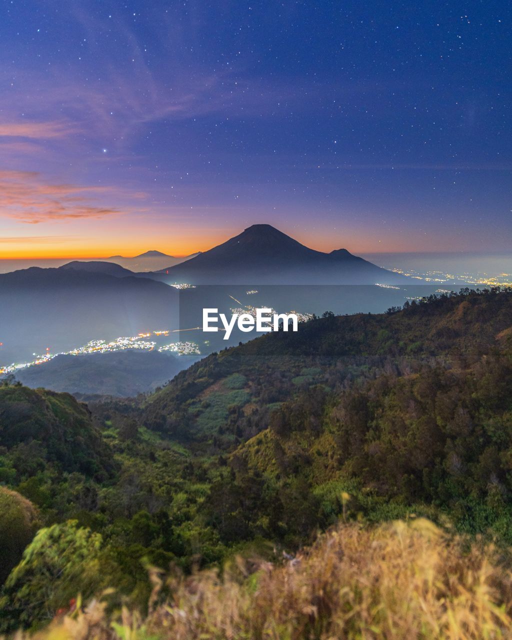 Scenic view of mountains against sky at night