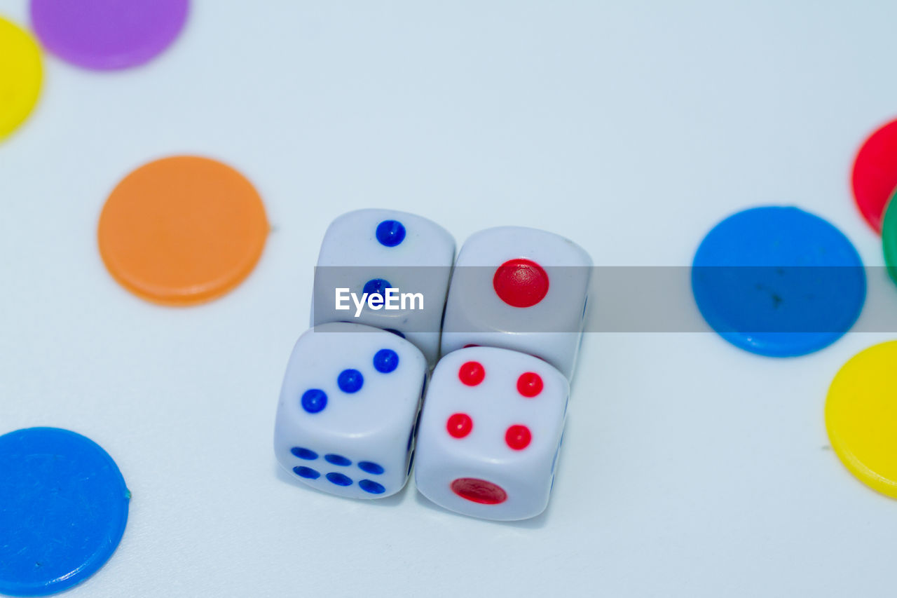 Close-up of multi colored dices on white background