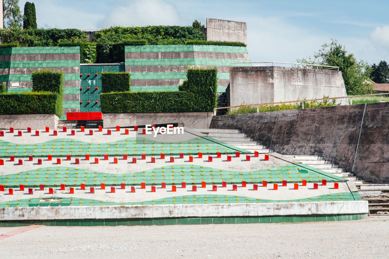 architecture, stadium, nature, built structure, plant, sky, building exterior, cloud, no people, outdoors, multi colored, day, sport venue