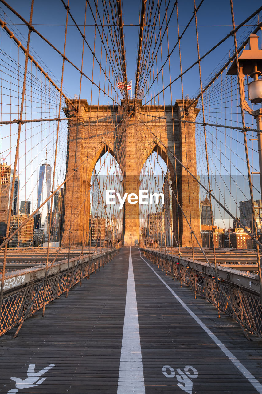 Brooklyn bridge against blue sky