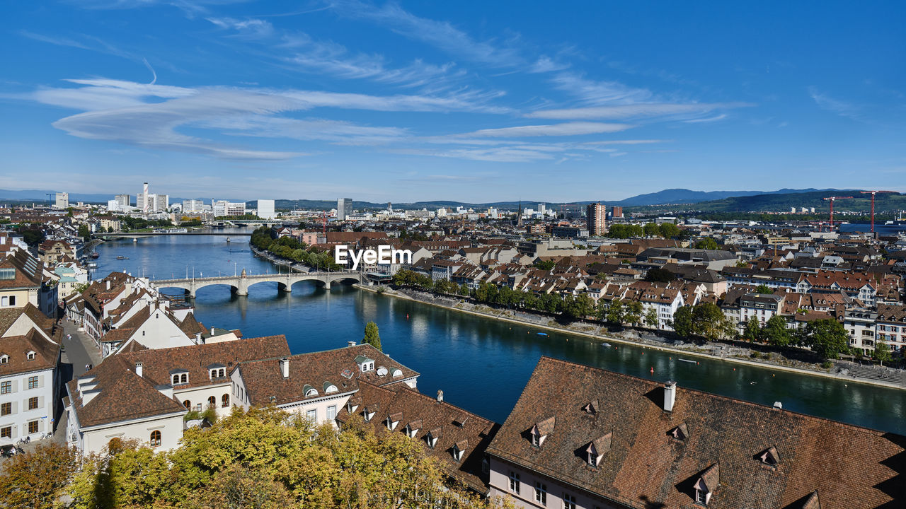 High angle view of city by river against sky