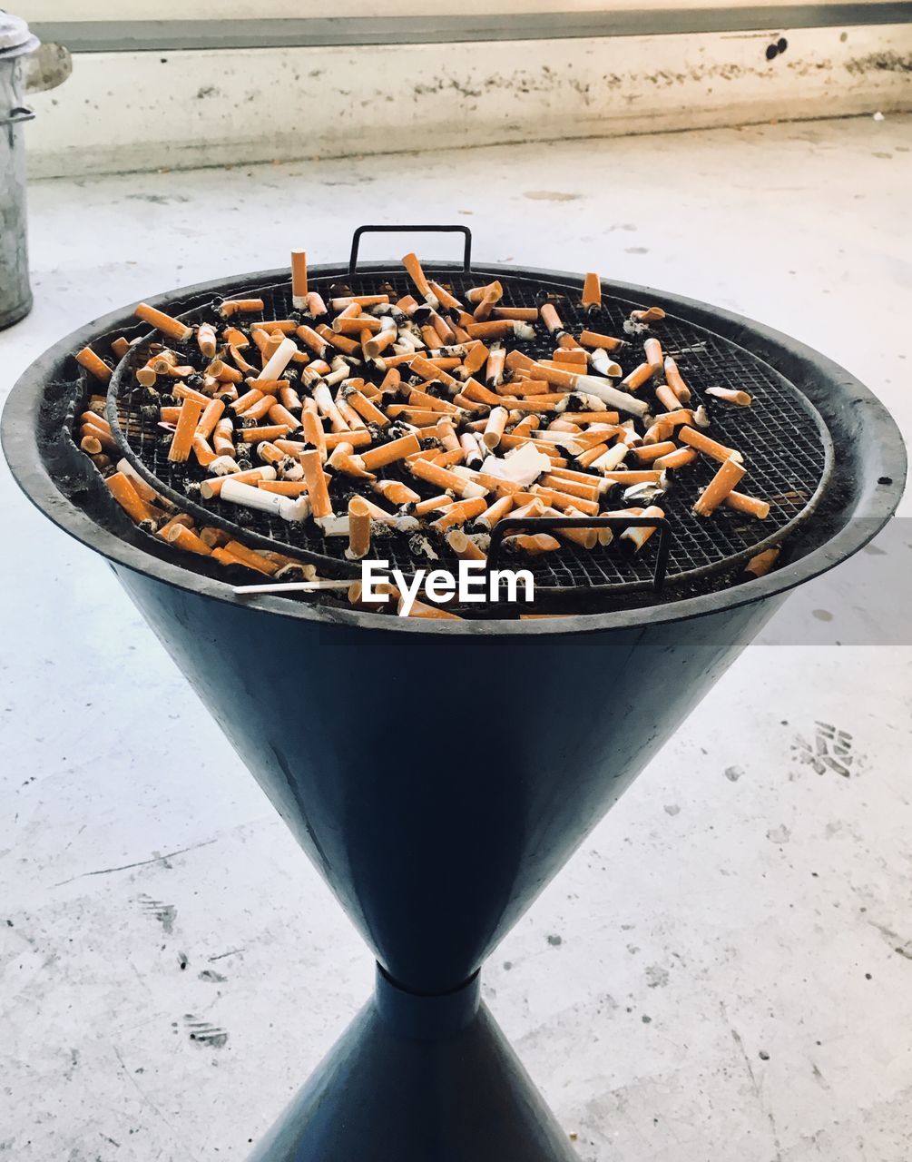 High angle view of cigarette butts on container