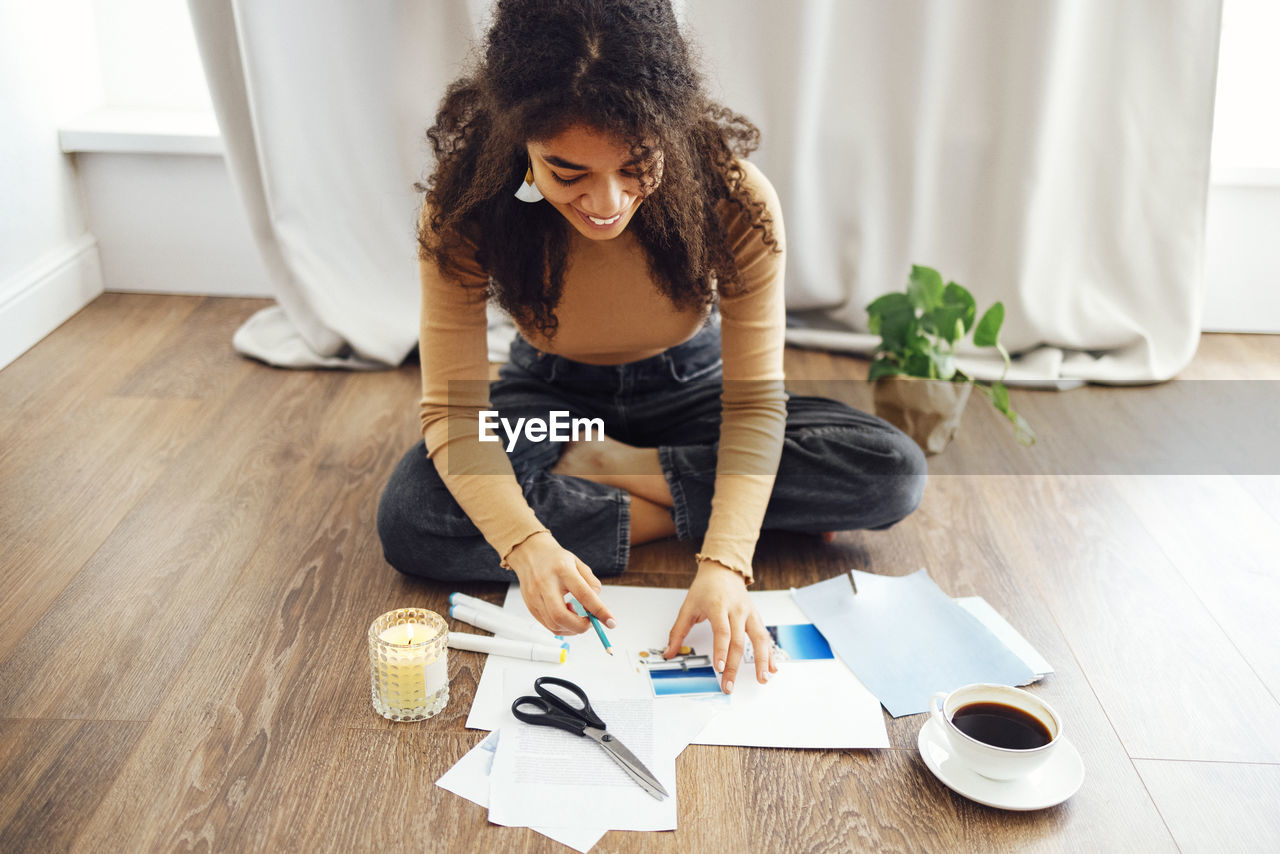 Smiling woman doing craft at home