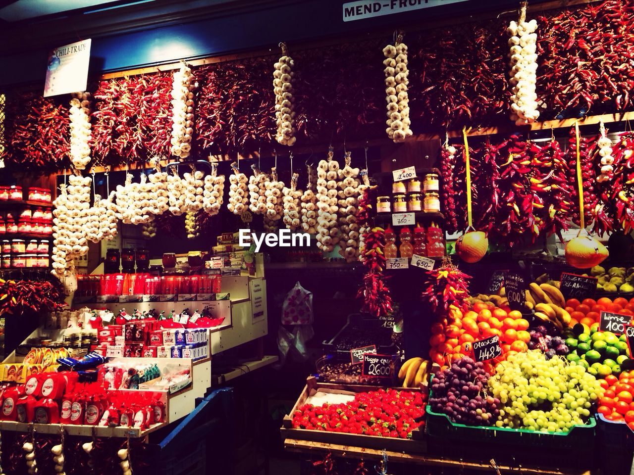 Various spices and fruits in market stall for sale