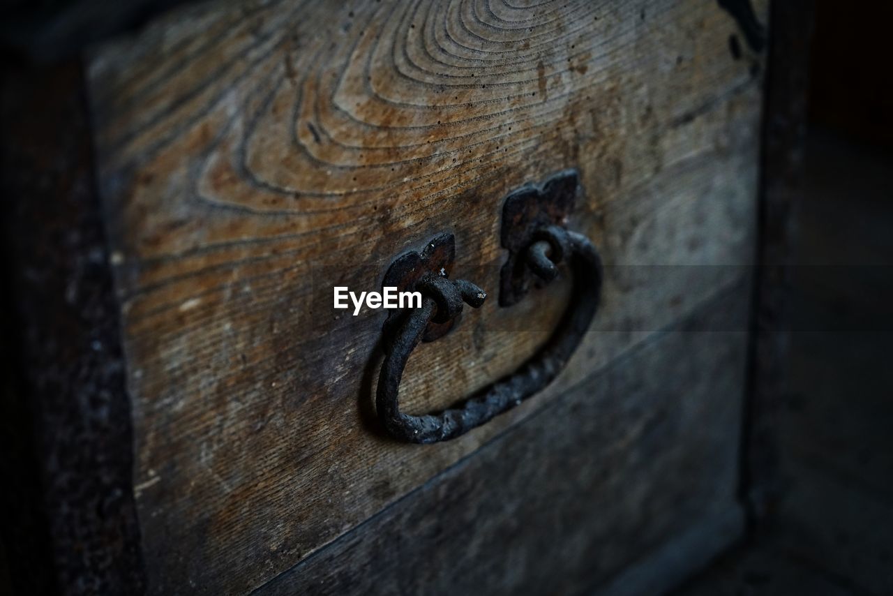 Close-up of doorknob on wood in church