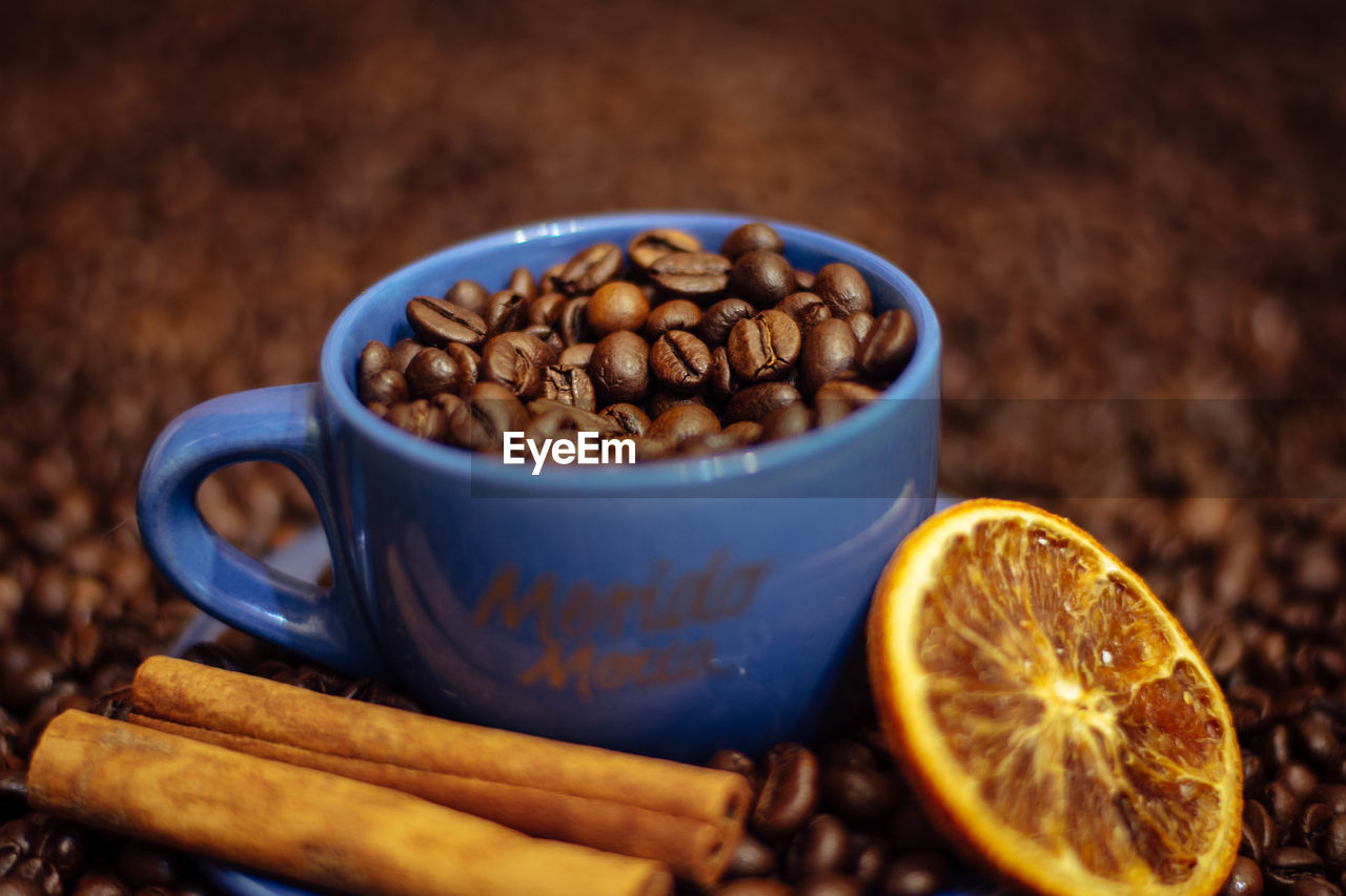 CLOSE-UP OF COFFEE CUP ON TABLE WITH SPOON