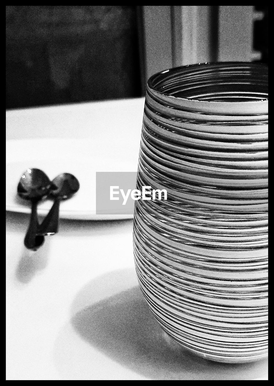 black and white, monochrome photography, transfer print, indoors, table, auto post production filter, no people, black, still life, monochrome, close-up, iron
