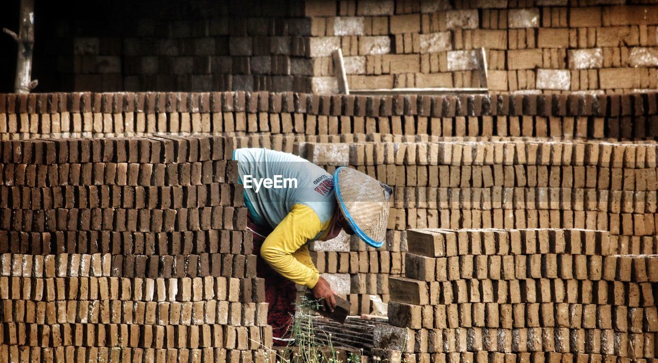 MAN WORKING WITH ARMS OUTSTRETCHED