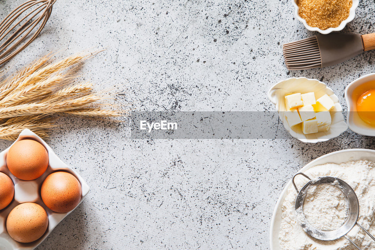 egg, food, food and drink, ingredient, healthy eating, freshness, wellbeing, flour, raw food, egg yolk, high angle view, still life, no people, kitchen utensil, directly above, indoors, animal egg, powder, table, baked, household equipment, shell, organic, breakfast, nature, kitchen, wire whisk, bowl