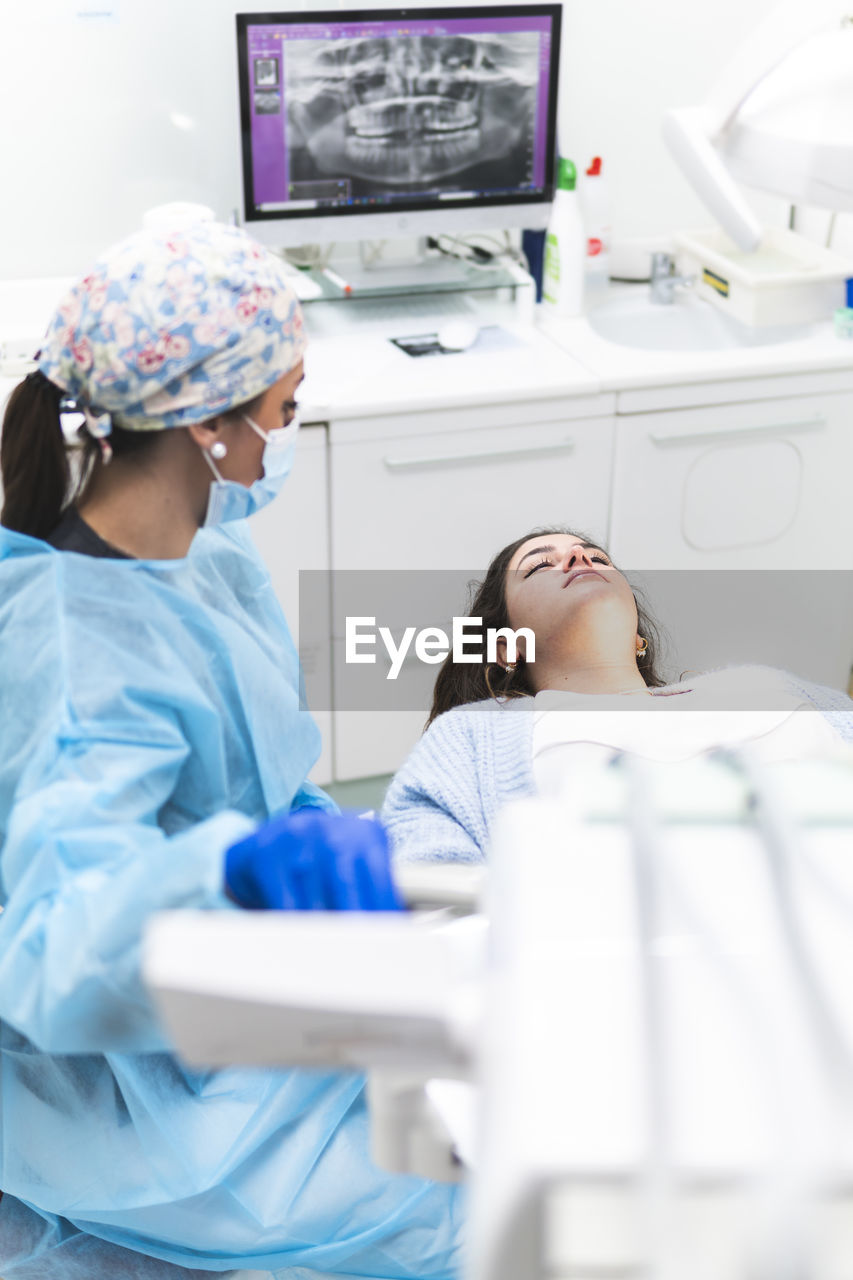 Dentist examining patient in dental clinic