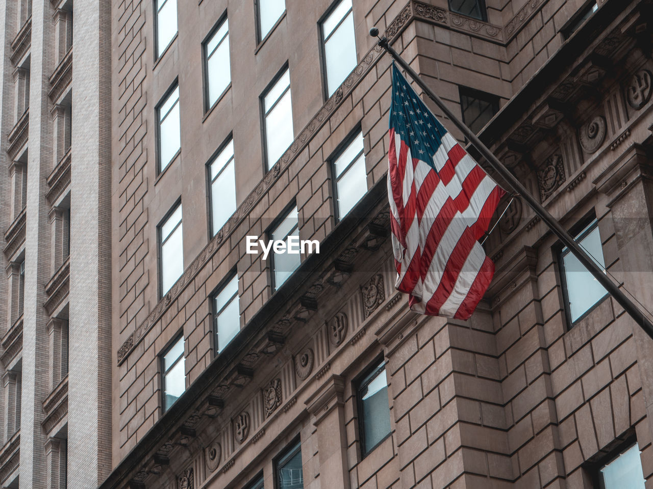 Low angle view of american flag against building