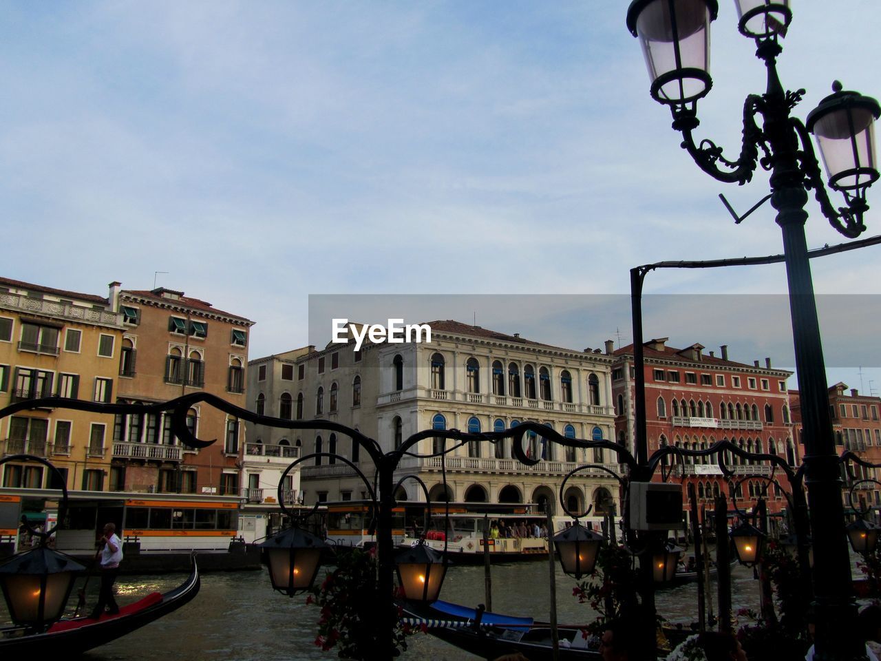Boats moored on shore against sky