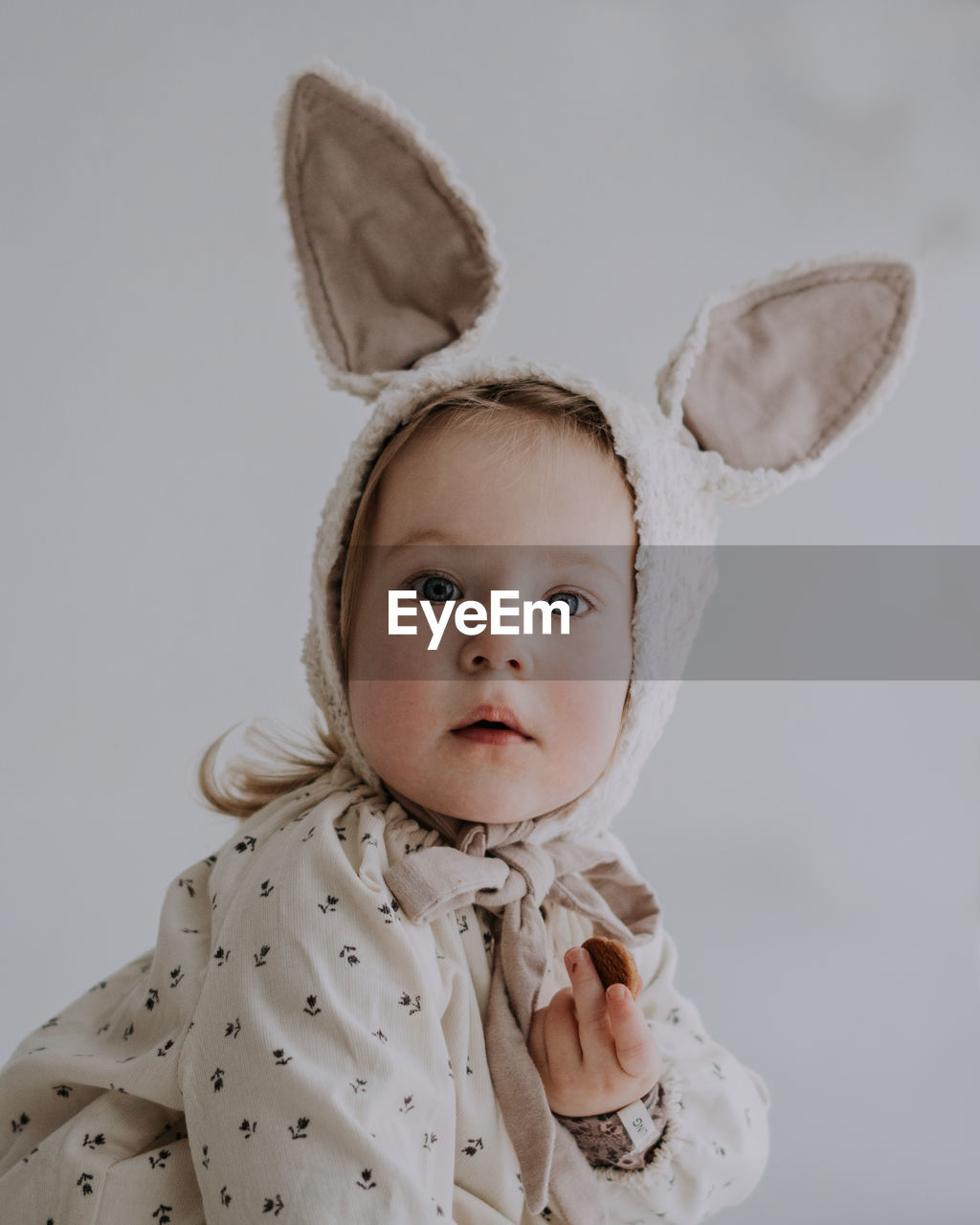 Toddler baby girl in funny hat with ears having fun