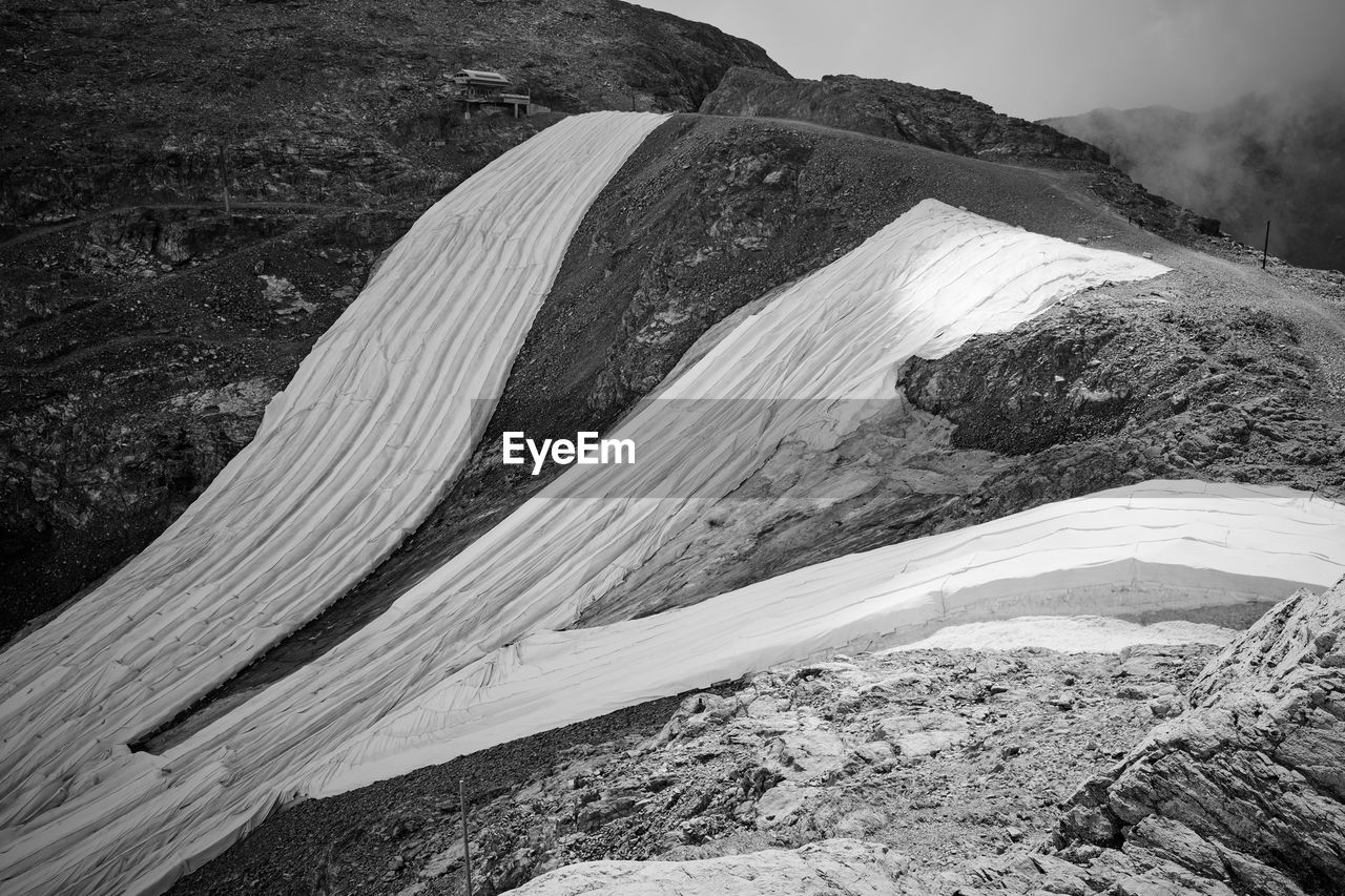 Artificial covering of the glacier due to climate change and to extend the ski season.