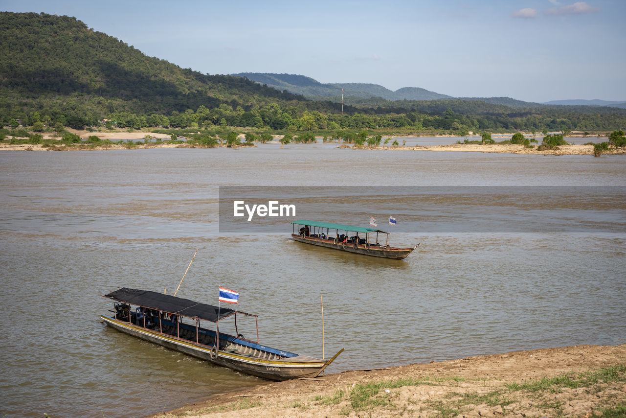 boat in sea against mountain