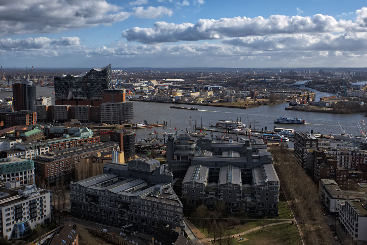 High angle view of buildings and river against sky