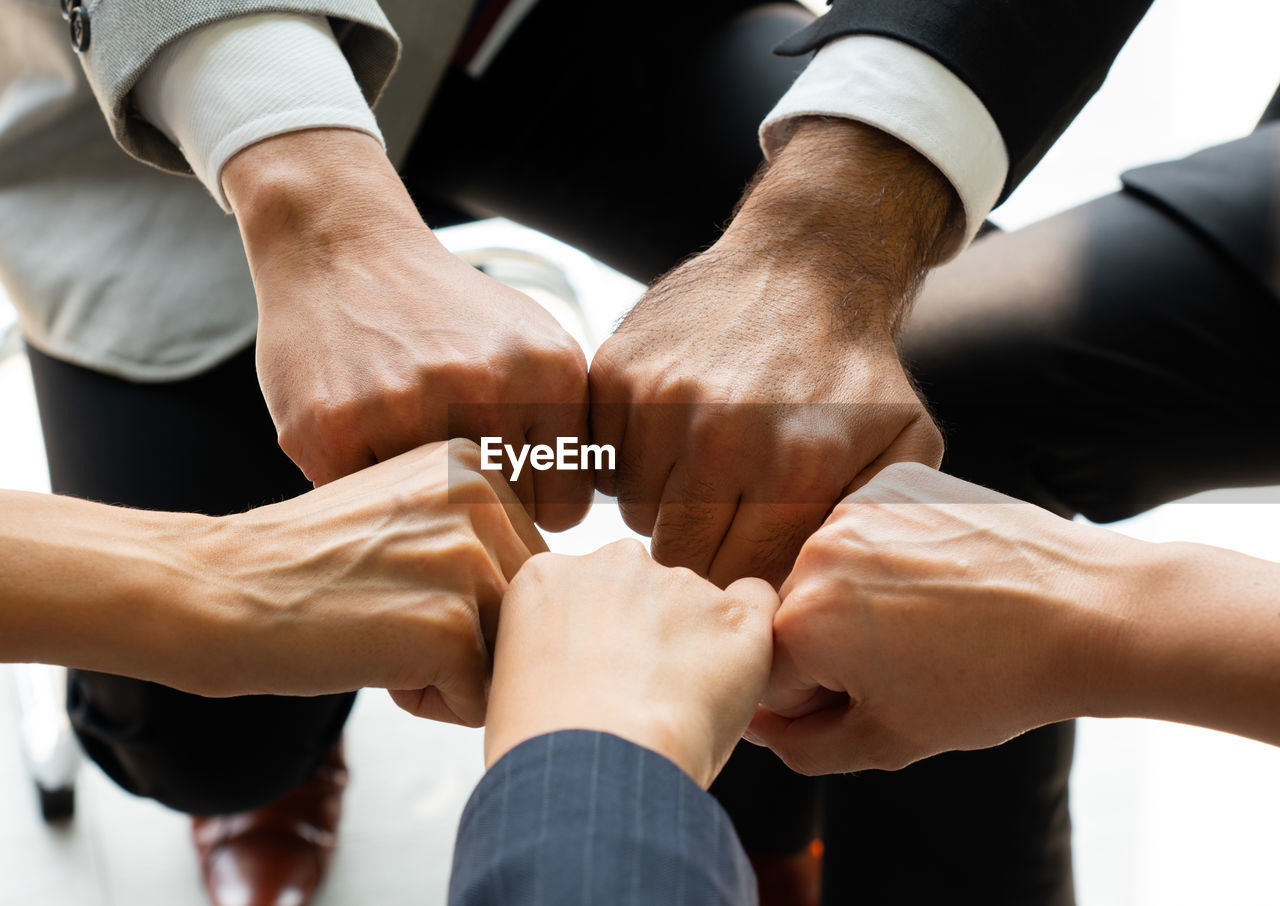 Cropped image of business persons doing fist bump