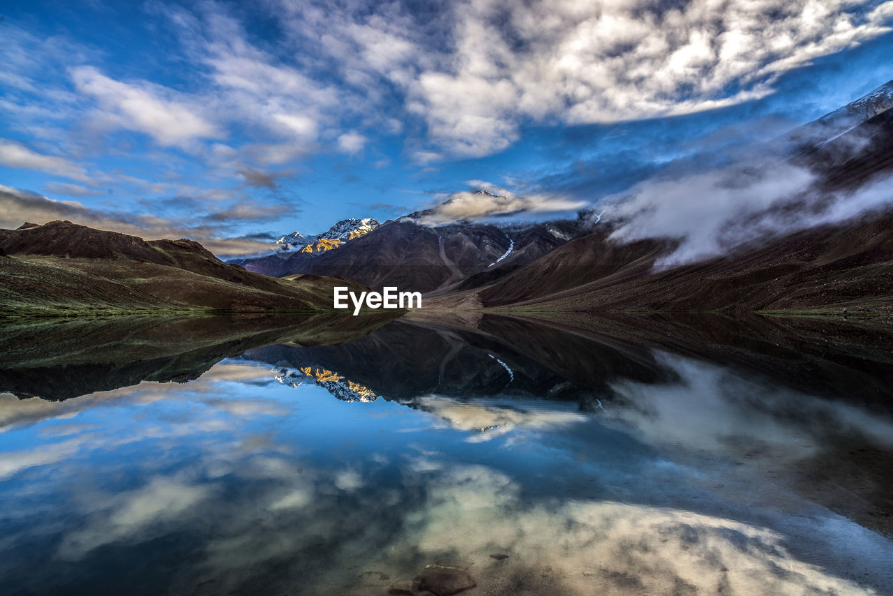 Scenic view of lake and mountains against sky