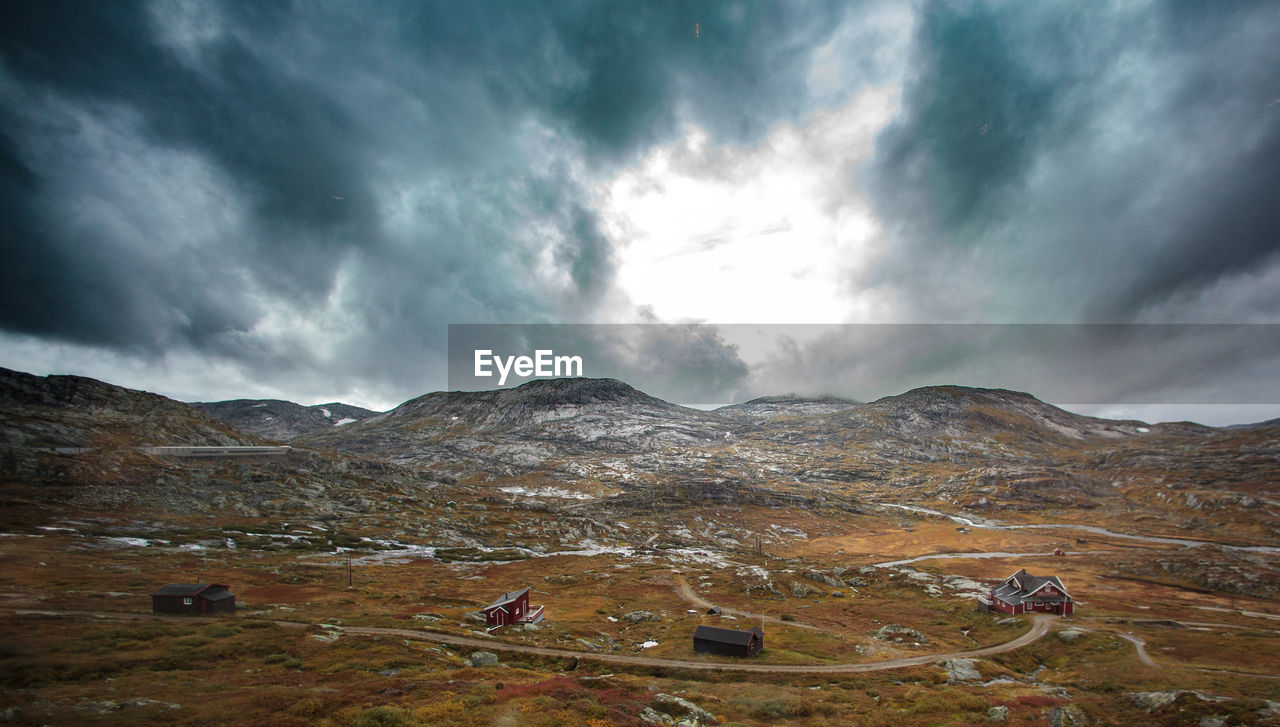 Scenic view of mountains against cloudy sky
