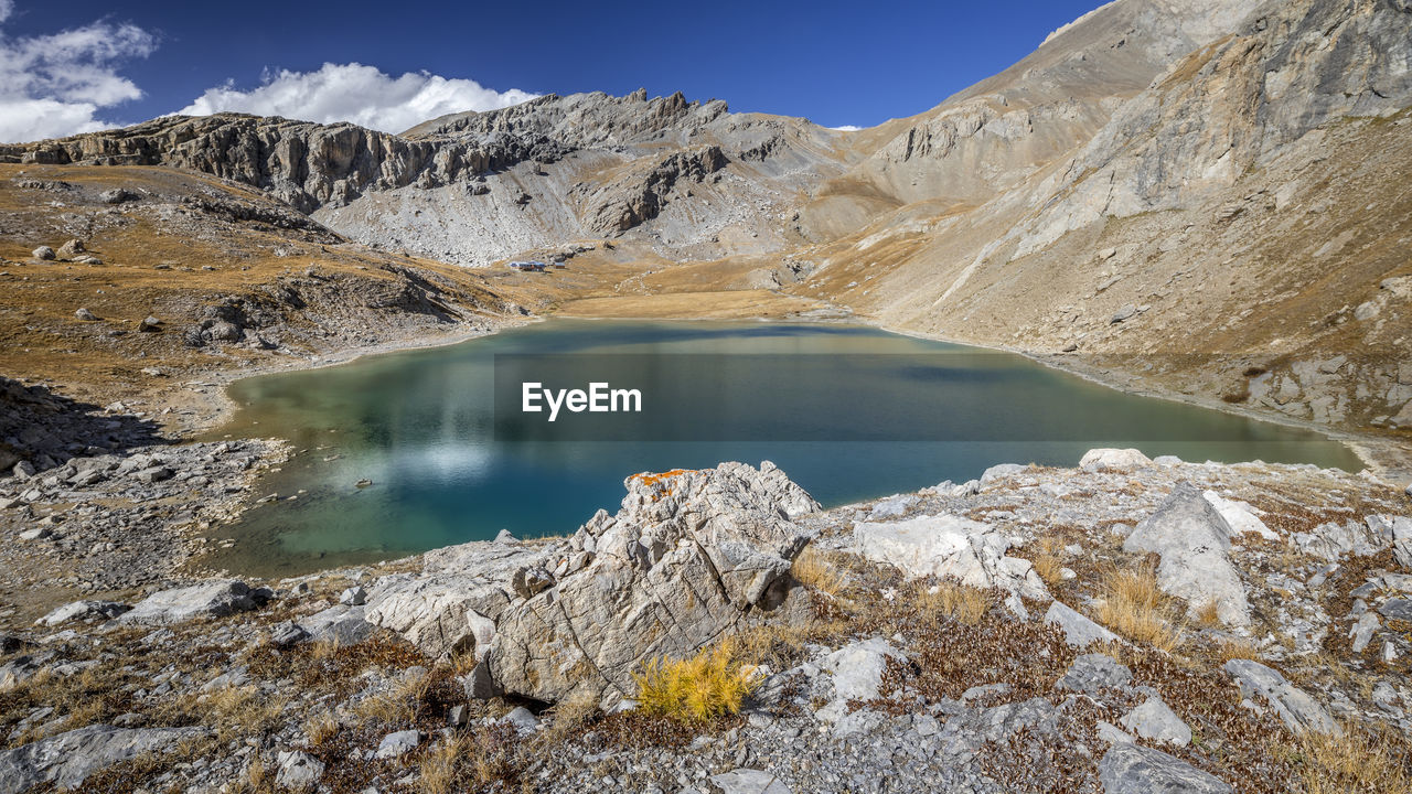 Scenic view of lake and mountains against sky