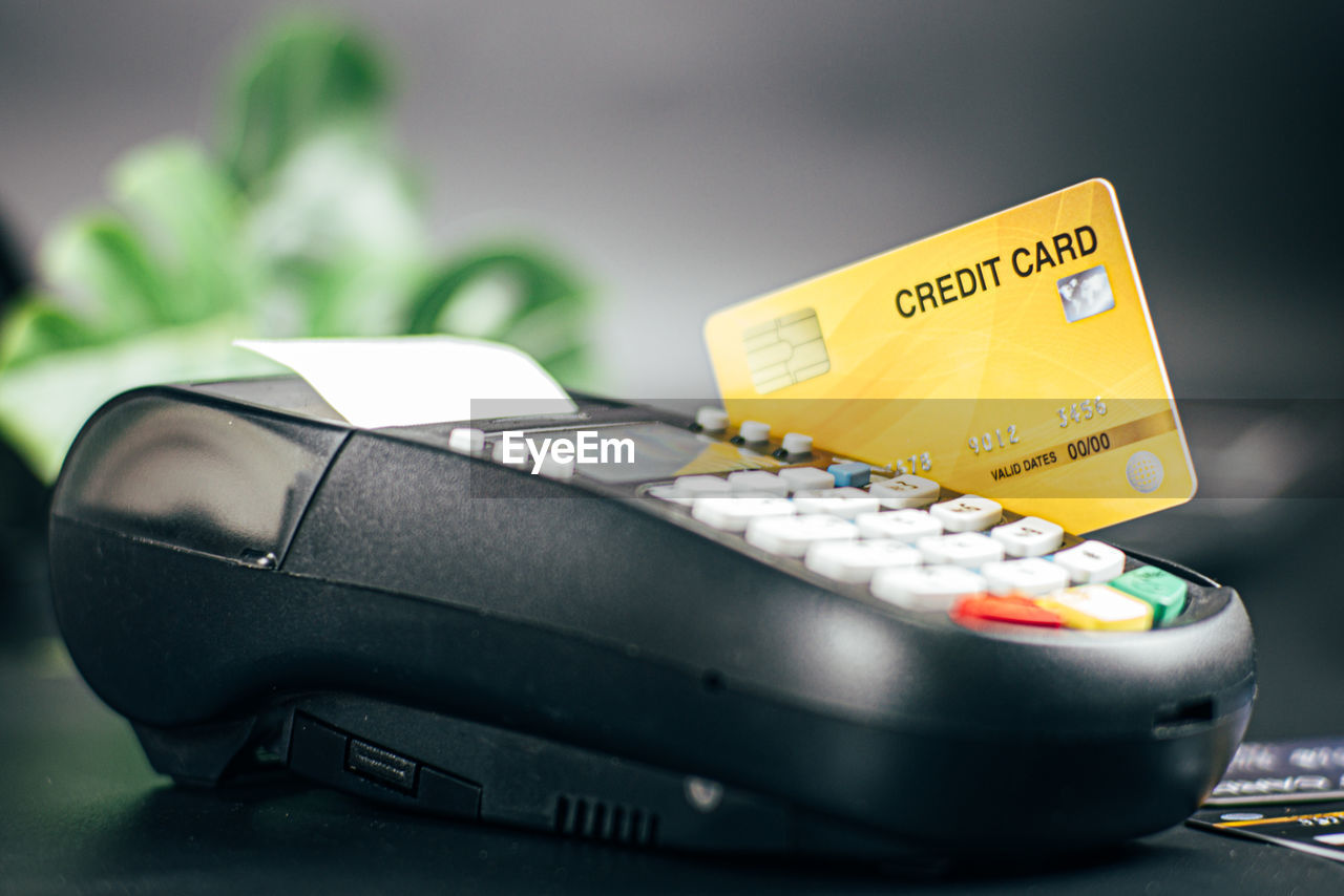 High angle view of credit cards in reader on table